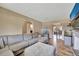 Open-concept living room with an aquarium, TV, and access to the dining area at 4612 E Seneca Ave, Tampa, FL 33617