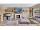 Cozy living room features a stone fireplace, floating shelves, and an eye-catching aquarium at 4612 E Seneca Ave, Tampa, FL 33617