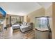 Comfortable living room with a large window, laminate flooring, and a custom aquarium at 4612 E Seneca Ave, Tampa, FL 33617