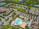 Aerial view of a neighborhood featuring a community pool, playground, green spaces, and well-maintained homes at 5003 Wabash Pl, Riverview, FL 33578