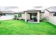 Expansive backyard featuring lush green grass and a charming covered patio, perfect for outdoor relaxation and entertaining at 5003 Wabash Pl, Riverview, FL 33578