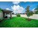 Lush, green backyard with a well-maintained lawn, bordered by a white fence, and a young tree adds to the scenery at 5003 Wabash Pl, Riverview, FL 33578