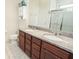 Bathroom features double sinks with granite countertops, ample storage, and tile floors at 5003 Wabash Pl, Riverview, FL 33578