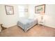 Bright, carpeted bedroom featuring a twin bed with blue comforter and matching décor at 5003 Wabash Pl, Riverview, FL 33578