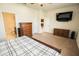 This bedroom features neutral carpet, access to the bathroom, and a ceiling fan at 5003 Wabash Pl, Riverview, FL 33578