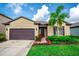 Inviting curb appeal with a lush green lawn, colorful landscaping, and a cozy front entrance at 5003 Wabash Pl, Riverview, FL 33578