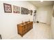 Hallway decorated with Gathering photos and flowers, leading to a white door on the right and closet straight ahead at 5003 Wabash Pl, Riverview, FL 33578