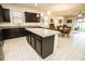 Open concept kitchen features a center island, granite countertops, stainless steel appliances and dark wood cabinetry at 5003 Wabash Pl, Riverview, FL 33578