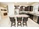 Modern kitchen featuring granite countertops, stainless steel appliances, and an island with bar seating at 5003 Wabash Pl, Riverview, FL 33578