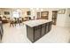 Open concept kitchen with a large center island, adjacent dining and living area at 5003 Wabash Pl, Riverview, FL 33578