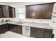 This kitchen features granite countertops, stainless steel appliances and dark wood cabinetry at 5003 Wabash Pl, Riverview, FL 33578