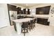 Spacious kitchen boasts granite countertops, stainless steel appliances, island with breakfast bar and dark cabinets at 5003 Wabash Pl, Riverview, FL 33578