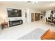 Bright living room with tile floor, recessed lighting, display shelves and cabinets, and open to dining area at 5003 Wabash Pl, Riverview, FL 33578