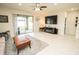 Living room features a sliding glass door to a backyard patio, a large TV, and tile flooring at 5003 Wabash Pl, Riverview, FL 33578