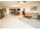 An open-plan living room features tile flooring, a kitchen with stainless steel appliances, and dining space at 5003 Wabash Pl, Riverview, FL 33578