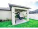 Backyard patio area perfect for outdoor seating with views of the grassy yard at 5003 Wabash Pl, Riverview, FL 33578