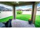Covered patio with stone floor looks out onto the lush, green back yard at 5003 Wabash Pl, Riverview, FL 33578