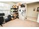 Cluttered room with disorganized shelving, boxes, office supplies, and neutral carpeting at 5003 Wabash Pl, Riverview, FL 33578