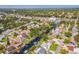 A tranquil aerial view of homes with canals and beautiful green trees with a distant highway at 51 Cypress Dr, Palm Harbor, FL 34684