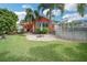 Lush backyard with a fire pit and pool; create your memories in this cozy outdoor space at 51 Cypress Dr, Palm Harbor, FL 34684