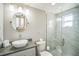 Modern bathroom with glass enclosed shower, vessel sink and neutral tones at 51 Cypress Dr, Palm Harbor, FL 34684