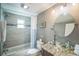 Bathroom featuring granite countertop, glass sink, tiled shower and bathtub at 51 Cypress Dr, Palm Harbor, FL 34684