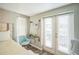 Bedroom area with a balcony, bright natural light and desk area at 51 Cypress Dr, Palm Harbor, FL 34684