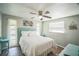 Bedroom featuring a queen bed, ceiling fan, and hardwood floors at 51 Cypress Dr, Palm Harbor, FL 34684