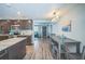 Open kitchen with island, stainless appliances, and adjacent dining area at 51 Cypress Dr, Palm Harbor, FL 34684