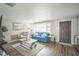 Cozy living room with a large window, hardwood floors, and a comfortable blue sofa at 51 Cypress Dr, Palm Harbor, FL 34684