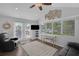 Cozy living room with vaulted ceiling, natural light, and views of outdoor pool at 51 Cypress Dr, Palm Harbor, FL 34684