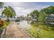 Picturesque waterfront view of the canal, showing boat access and tropical landscaping, a boater's dream at 51 Cypress Dr, Palm Harbor, FL 34684
