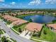 Aerial view showcases this single Gathering home with lush landscaping and a serene lake view at 5422 Sunset Falls Dr, Apollo Beach, FL 33572