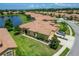Stunning aerial view of the home with lake view and well-manicured landscaping at 5422 Sunset Falls Dr, Apollo Beach, FL 33572