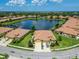 This aerial view shows the single Gathering home has a water view and beautiful blue skies above at 5422 Sunset Falls Dr, Apollo Beach, FL 33572