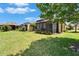 A view of the screened-in lanai and lush green backyard space at 5422 Sunset Falls Dr, Apollo Beach, FL 33572