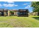 Expansive backyard featuring a screened-in lanai and well-maintained lawn at 5422 Sunset Falls Dr, Apollo Beach, FL 33572