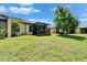 A view of the screened lanai with backyard landscaping and trees at 5422 Sunset Falls Dr, Apollo Beach, FL 33572