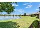 Lush green backyard overlooking the peaceful lake, offering a tranquil outdoor space at 5422 Sunset Falls Dr, Apollo Beach, FL 33572