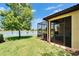 Inviting screened lanai overlooking the lush lawn and serene lake views on a sunny day at 5422 Sunset Falls Dr, Apollo Beach, FL 33572