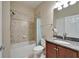 Bright bathroom features granite vanity, neutral tile, and tub with shower at 5422 Sunset Falls Dr, Apollo Beach, FL 33572
