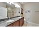 Bathroom featuring double sinks, granite countertops, and a glass-enclosed shower at 5422 Sunset Falls Dr, Apollo Beach, FL 33572
