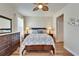 Comfortable bedroom with ceiling fan, wood accents, and seahorse-themed bedding for a serene retreat at 5422 Sunset Falls Dr, Apollo Beach, FL 33572