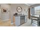 A stylish beverage center, with granite counters and a wine fridge, adds a touch of luxury to the dining area at 5422 Sunset Falls Dr, Apollo Beach, FL 33572