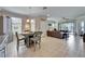 Open concept living with dining area flowing into the living room, showcasing the seamless indoor-outdoor living at 5422 Sunset Falls Dr, Apollo Beach, FL 33572