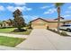 Exterior of home with a well-manicured lawn, long driveway, and a two car garage at 5422 Sunset Falls Dr, Apollo Beach, FL 33572