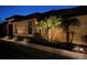 Exterior view of home at night, highlighting manicured landscaping and accent lighting at 5422 Sunset Falls Dr, Apollo Beach, FL 33572