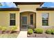 Charming home featuring a screened entrance, manicured landscaping, and neutral exterior paint at 5422 Sunset Falls Dr, Apollo Beach, FL 33572
