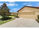 View of the exterior and two car garage at 5422 Sunset Falls Dr, Apollo Beach, FL 33572