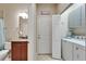 Hallway featuring bathroom and laundry room, with exterior door at 5422 Sunset Falls Dr, Apollo Beach, FL 33572